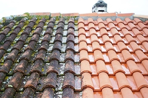 a roof with only the half of the tiles are cleaned